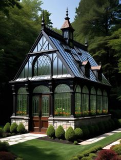 a large glass house in the middle of some bushes and trees with lots of windows