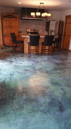 an image of a kitchen floor that has been cleaned and stained with blue green paint