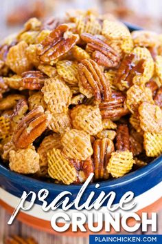 a blue bowl filled with pecans sitting on top of a table