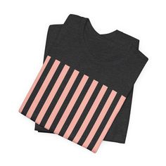 Introducing our Coral Pink Stripes Shirt, a feminine and chic addition to your wardrobe. Made with pretty pink and white vertical stripes, this classic t-shirt brings a cute and stylish touch to any casual outfit. This classic unisex jersey short sleeve tee fits like a well-loved favorite. These soft cotton t-shirts have-ribbed knit collars to bolster shaping. The shoulders are tapered for a better fit over time. Dual side seams hold the garment's shape for longer. .: Made with 100% Airlume comb Black Vertical Stripes Top For Spring, Black Vertical Striped Top For Spring, Black Tops With Vertical Stripes For Summer, Casual Black Tops With Vertical Stripes, Black Summer Tops With Vertical Stripes, Trendy Cotton Tops With Vertical Stripes, Trendy Striped Crew Neck Shirt, Casual Pink Tops With Contrast Stripes, Black Shirt With Vertical Stripes For Spring