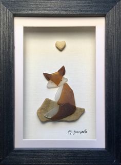 a framed picture of a fox with a heart