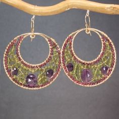 Hammered hoops rhodolite garnet, vessonite, and amethyst Bohemian 122 by CalicoJunoJewelry on Etsy https://www.etsy.com/listing/180852399/hammered-hoops-rhodolite-garnet Purple Fusion Style Round Jewelry, Unique Amethyst Earrings With Natural Stones, Handmade Peridot Round Earrings, Handmade Round Peridot Earrings, Handmade Green Amethyst Gemstones, Unique Amethyst Jewelry With Matching Earrings, Purple Handmade Fine Jewelry Earrings, Handmade Fine Jewelry Amethyst Gemstones, Handmade Fine Amethyst Gemstones