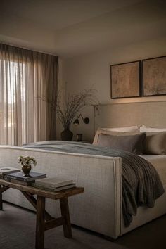 a large bed sitting next to a window in a bedroom