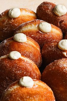 several donuts covered in icing and white powdered sugar