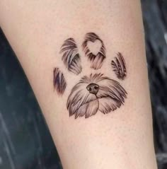 a dog's paw with feathers drawn on it