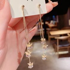 Very Lovely Golden Floral Tassel Earrings. These Earrings Are Unique, Gorgeous, And Very Creative. So Elegant With It's Long 18k Fill Chain, That Connect To Beautiful Golden Floral Leaves That Lays On Top Of A 7mm Stunning Sparkling Clear Crystals That Shine Remarkably, The Back Tassel Is Connected To A Butterfly Backing, Light Weight And Moves With You With Ease. Appox. 3" Long. Long Length Accentuates The Neck And Jawline Very Romantic Great For Any Occasion 100% Brand New And Boutique Gold Tassel Drop Earrings For Gifts, Gold Tassel Earrings With Latkans For Gift, Gift Flower Earrings With Latkans, Earring Long, Floral Leaves, Clear Crystals, Crystal Flower, Drop Earring, Tassel Earrings