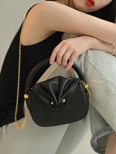 Editor's Noteeclaaire presents a shell-shaped mini bag with black body and gold hardware.- Design that inspired by seashell shape- Flap bag with simple body- Mini-sized bag that gives a lovely mood- 100% premium cow leather used with chamude lining*Chain strap is optional item and requires additional purchaseMeasurements (in.)- Size: 6.69 in. * 5.12 in. * 2.36 in.- Short strap: Width 0.51 in.- Simple chain strap: 43.3 in.- Round chain strap: 43.3 in.- Double chain strap: 43.3 in. Compositio Simple Chain, Double Chain, Black Body, Mens Outerwear, Men Shoes Size, Flap Bag, Natural Leather, Chain Strap, Cow Leather