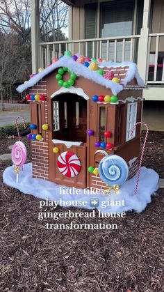 a gingerbread house with candy and lollipops on the front porch for christmas