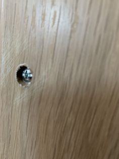 a wooden door with some screws in it