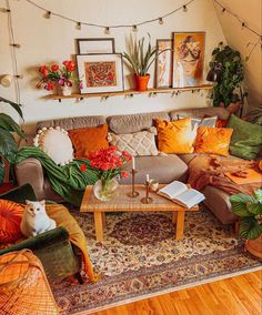 a living room filled with lots of furniture and plants on top of the couches