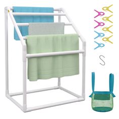 three towels are hanging on a rack with scissors and other items in front of it