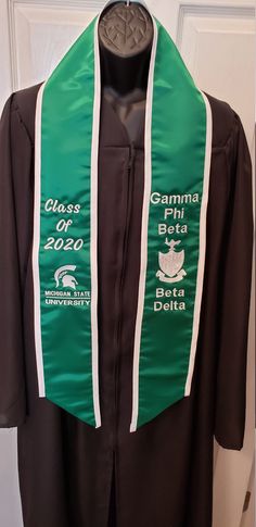 "Custom Embroidered Graduation Stole with Slant Bottom/Trim/Greek or English Letters/Class of 2020/Personalized Stole Polyester Satin Graduation Stole with Slant Bottom and Trim CURRENT PRODUCTION TIME(S) - Text Only 3 Days Text & Graphics* 7 days *Graphics will need to be digitized - please allow additional time for processing. Size 5\" wide X 72\" long (overall) Polyester Satin Embroidery Custom made with your choice of design elements. BASE PRICE: $20.00 = no embroidery Please list what y Text Elements, Embroidery Custom, Graduation Sash, Satin Embroidery, Text Graphics, Graduation Stole, English Letters, Class Of 2020, Greek Letters