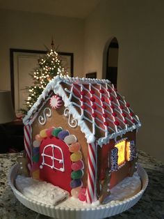 a decorated gingerbread house sitting on top of a table