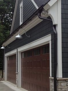 two garages with brown doors and white trim