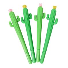 three green cactus shaped pens sitting next to each other