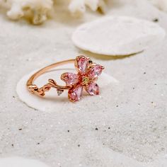 Celebrate the Spring Season with this gorgeous sparkling pink sapphire flower ring ~ perfect for everyday wear or for a special occasion. Makes the perfect gift for any occasion. * 18K Rose Gold Filled *Flower size is approximately 1x1cm * Lab created sapphire *Nickle and Lead Free *Size 6 and 7 only * Photos enlarged to show detail * Ring box included *For returns/refunds please contact me within 3 days, please ship items back in original condition within 7 days of receipt. Pink Flower Engagement Ring, Rose Gold Flower Ring, Pink Flower Ring, Cherry Blossom Ring, Cute Promise Rings, Lily Ring, Pink Wedding Rings, Bff Jewelry, Gold Flower Ring