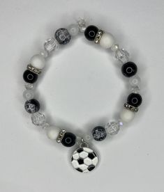 a black and white beaded bracelet with a soccer ball charm