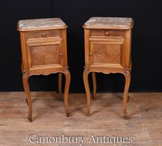 two wooden nightstands sitting next to each other