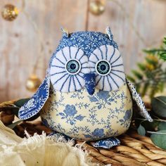 a blue and white owl sitting on top of a basket