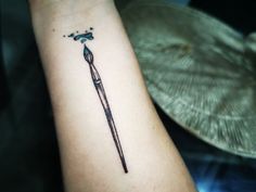 a tattoo on the arm of a person with a toothbrush