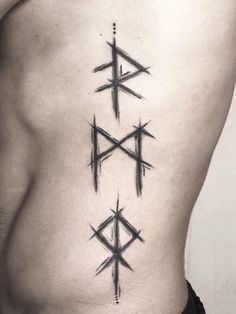 a man's lower back tattoo with three different symbols on his chest and the other side