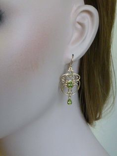 Capture the spirit of vintage appeal & a touch of glamour with these gorgeous Victorian chandelier drop earrings! These superbly crafted earrings have been handmade in 9ct Solid Yellow Gold with reference to a vintage design. A luxurious bezel set oval cut NATURAL Peridot sits in the centre and is surrounded by filigree patterns while a pear shaped bezel set NATURAL Peridot dangles from the chandelier capturing the attention of onlookers. French hook wires attach to these earrings which will Nickel-free Peridot Elegant Jewelry, Elegant Peridot Nickel-free Jewelry, Elegant Nickel-free Peridot Jewelry, Classic Gold Peridot Jewelry, Classic Gold Jewelry With Peridot, Elegant Pierced Peridot Jewelry, Classic Pierced Jewelry For May Birthstone, Elegant Oval Peridot Earrings, Elegant Peridot Earrings For Anniversary