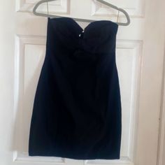 a black dress hanging on a white door