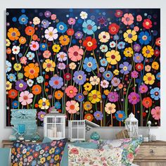 a living room with flowers painted on the wall