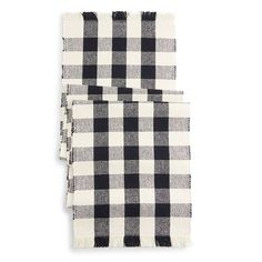 two black and white plaid napkins on a white background, one with fringe ends