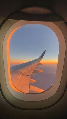 an airplane window looking out at the sky