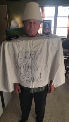 an old man wearing a white shirt with the words one night stand written on it