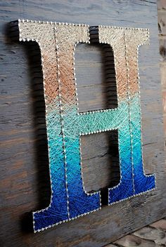 the letter h is made out of glass and wood