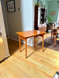 a wooden table sitting on top of a hard wood floor