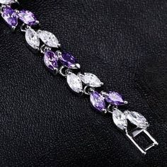 Romantic. Classy. Delicate. Rhodium plated for a flawless finish which perfectly enhances the intricate detailing, this exquisite bracelet will add a touch of sophistication to any wedding gown or formal ensemble. Each link is adorned with flawlessly faceted purple and clear cubic zirconia that capture the light from every angle with a perfectly translucent appeal, sparkling beautifully. Available in two lengths: 6.5" (approx. 16.5cm) and 7.75" (approx. 19.6cm). To make your choice select your p Elegant Hand Set Cubic Zirconia Chain Bracelet, Elegant Hand-set Cubic Zirconia Chain Bracelet, Hand Set Cubic Zirconia Elegant Chain Bracelet, Elegant Cubic Zirconia Chain Bracelet Hand Set, Elegant Cubic Zirconia Charm Bracelet For Anniversary, Elegant Charm Bracelet For Anniversary, Elegant Anniversary Charm Bracelet, Elegant Formal Cubic Zirconia Chain Bracelet, Elegant Cubic Zirconia Chain Bracelet For Formal Occasions