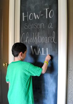 a young boy writing on a chalkboard with the words how to season a chalkboard wall