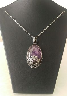 This amethyst gemstone pendant is a wonderful gift to yourself or to your loved one.This gemstone necklace is 17.7 inches length.Amethyst necklace is 1 inches width and 1.20 inches height. This gemstone pendant is wrapped in beautiful Victorian Style filigrees.(antiqued silver plated brass) Helps Purple Amethyst Oval Pendant Jewelry, Purple Gemstone Oval Pendant Necklace, Purple Gemstone Necklace With Oval Pendant, Spiritual Purple Cabochon Jewelry, Amethyst Flower Pendant Jewelry Gift, Amethyst Flower Pendant Jewelry For Gift, Purple Amethyst Oval Pendant Necklace, Purple Cabochon Pendant Jewelry, Oval Amethyst Cabochon Necklace