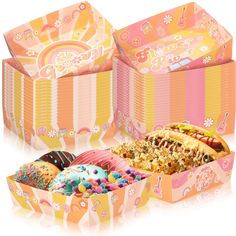 an open box filled with lots of donuts and sprinkles next to each other