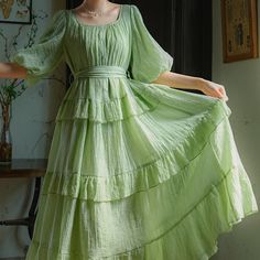 A fresh green forest that sparkles like a jewel in the sunlight. A dress with bright and refreshing colors. The sleeves are fluffy puff sleeves, and the skirt part has a tiered design that looks like layers. You will be fascinated by the way it sways softly and gracefully. 
 
 ＜Size＞ 
 
 S size
 
 Length: 120cm 
 
 Shoulder width: 35cm 
 Bust: 108cm 
 
 Sleeve length: 37cm 
 
 
 M size
 
 Length: 122cm 
 
 Shoulder width: 36cm 
 Bust: 112cm 
 
 Sleeve length: 38cm 
 
 
 
 
 ＜Material＞ 
 
 Lyocel Green Tiered Ruffle Midi Dress, Green Tiered Midi Dress With Ruffles, Green Tiered Midi Dress With Ruffle Hem, Tiered Maxi Dress With Gathered Sleeves, Green Summer Dress With Gathered Sleeves, Tiered Puff Sleeve Dress For Garden Party, Green Puff Sleeve Maxi Dress For Summer, Green Maxi Dress With Gathered Sleeves, Spring Tiered Dress With Gathered Sleeves