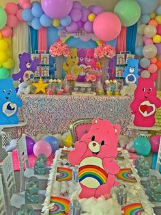 there is a table set up with balloons and teddy bears