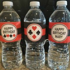 three water bottles with happy birthday labels on them