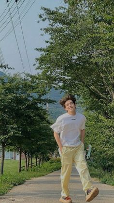 a young man riding a skateboard down a road