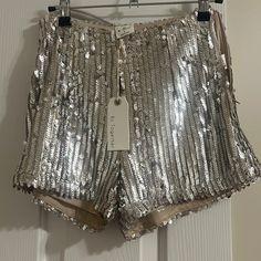 Side Zip Sequin Shorts. Chic Sequined Shorts For Spring, Shimmer Bottoms For Summer Night Out, Shimmer Bottoms For Night Out In Summer, Summer Shimmer Bottoms For Night Out, Summer Night Out Shimmer Bottoms, Metallic Sequined Bottoms For Summer, Sequined Short Bottoms For Spring, Short Sequined Bottoms For Spring, Spring Silver Sequined Bottoms