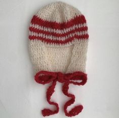 a crocheted hat with red and white stripes