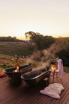 an outdoor bathtub on a deck with candles