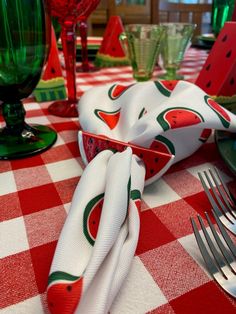 a red and white checkered table cloth with watermelon napkins