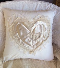 a white pillow with a heart on it