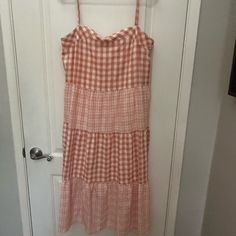 Never Worn. Size Medium But Dress Does Not Have Size Tags. Midi Length, Babydoll Style. Excellent Condition Casual Tiered Dress For Picnic, Casual Tiered Gingham Dresses, Casual Gingham Tiered Dress, Casual Peach Sleeveless Sundress, White Cotton Sundress For Picnic, Peach Sundress For Brunch, Casual Peach Sundress For Spring, Cotton Tiered Sundress For Brunch, Tiered Cotton Sundress For Brunch