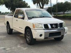 a white pick up truck parked in a parking lot