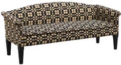 a black and white patterned couch with wooden legs