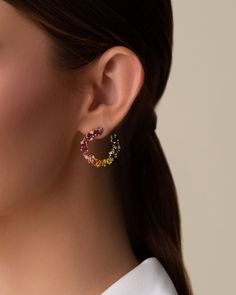 Handcrafted with 14-karat gold, these spiral hoops are meticulously set with vibrant rainbow gemstones and brilliant round diamonds. These gorgeous earrings are an effortless way to make a bold statement for any occasion. Details 14k yellow gold 4x2mm baguette-cut rhodolite, pink topaz, morganite topaz, peridot topaz, green envy topaz and English blue topaz 3x3mm princess-cut rhodolite, pink topaz, morganite topaz, peridot topaz, citrine and English blue topaz 4x4mm clover-cut peridot topaz, cit Rainbow Sapphires, Rainbow Gemstones, Red Ombre, Pink Topaz, Lemon Quartz, Baguette Cut, Green Amethyst, Stunning Earrings, Topaz Gemstone